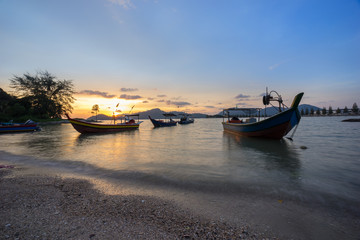 Fisherman boat at the beach during sunset
