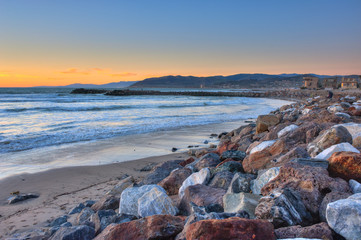 Ocean water lapping up against the rocks. 