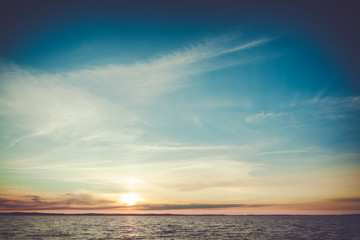 Fototapeta na wymiar Calm sunset and clouds over lake