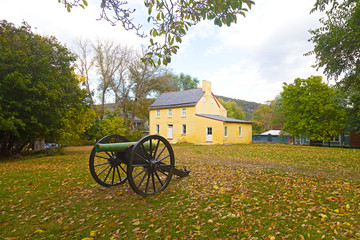 Historic battlefield cannon in Harpers Ferry, West Virginia, USA. Historic town in autumn with displayed old military artifact.