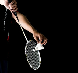 badminton player holding racket and shuttlecock - obrazy, fototapety, plakaty