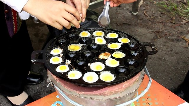 Fried Quails egg in the boiling pan Thailand Food