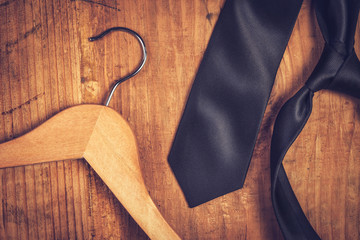 Elegant black tie and cloth hanger - obrazy, fototapety, plakaty