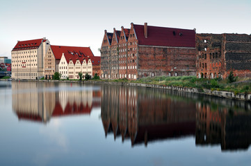 Fototapeta premium Old industrial area of Gdansk, Poland. Coastal homes reflected in water. 