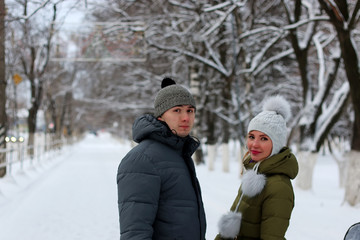 Fototapeta na wymiar couple of lovers walk in winter park