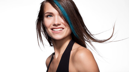 Portrait of a smiling girl with long hair color on a white background