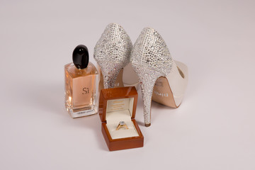 Wedding Ring, Shoes and Perfume on white background