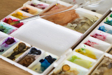 plastic artist color palette on wooden floor art concept focus o