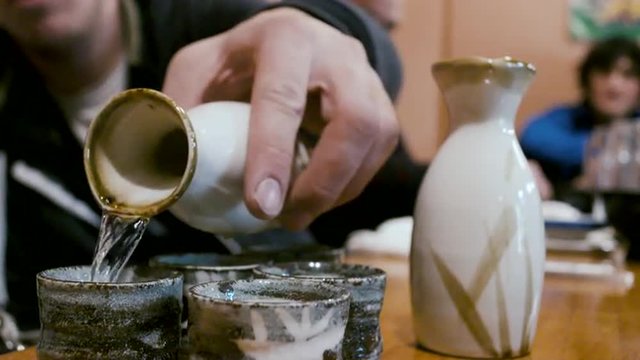 Man Pouring Sake in a Japanese Restaurant