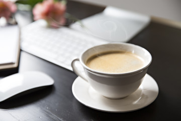 Cup of coffee and a computer at work . a coffee break