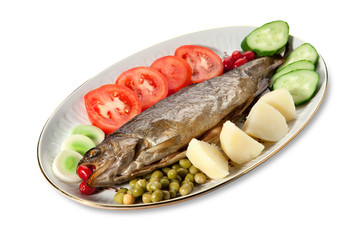 Baked trout with vegetables on the plate on a white background