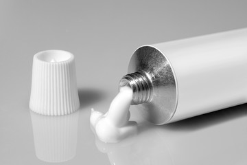 tube of white color on a gray background