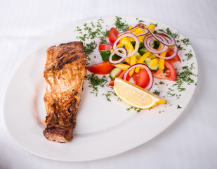 Grilled salmon fillet with vegetable salad.