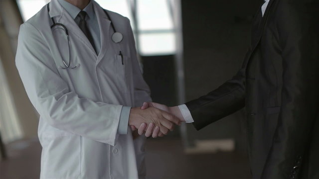 doctor with a patient family at bright modern office in hospital