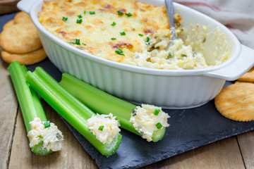 Baked crab dip, served with celery sticks and crackers