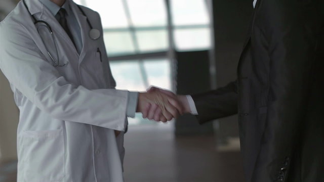 doctor with a patient family at bright modern office in hospital