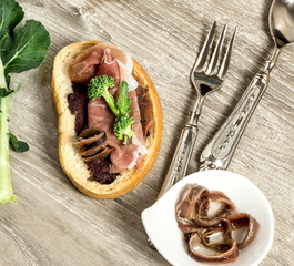 bruschetta with olive paste, parma ham, broccoli and ANCHOVY