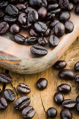 macro shot of roasted coffee beans on wooden board