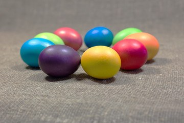 Easter colored eggs on dark green rough cotton texture art conce