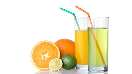 glasses of orange and lime juices with orange and lime fruits