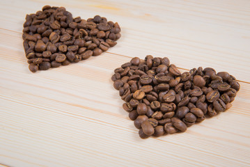 Heart shape made from coffee beans on wooden surface. coffee in the shape of a heart. Valentine's Day, concept of love.
