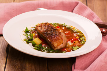 Spanish hot vegetable soup with duck breast. Rustic style. Toned image. Top view