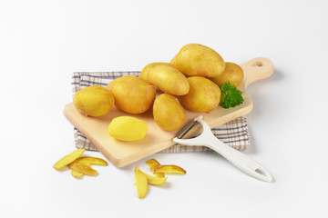 fresh potatoes on cutting board