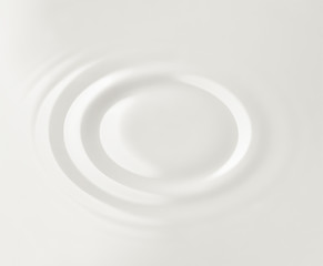 Milk. Circles on the surface of the milk