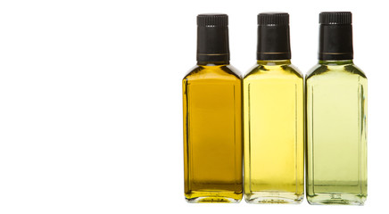 Avocado oil, olive oil and rapeseed oil over white background