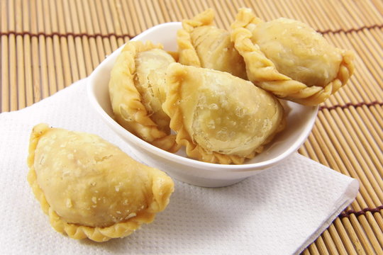 Curry puff on bamboo mat