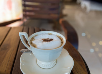 cappuccino coffee in white cup on saucer