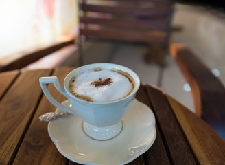 cappuccino coffee in white cup on saucer