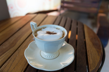 cappuccino coffee in white cup on saucer