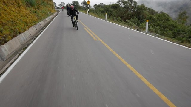 Man cycling on Peruan mountain road, slow motion