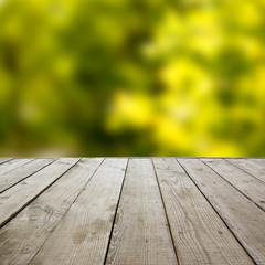 Wooden perspective floor with planks on blurred natural summer b