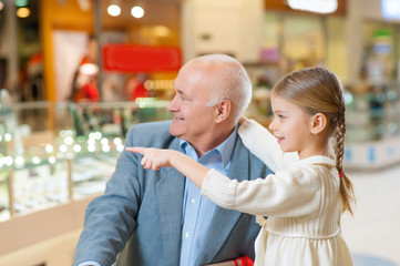 Old grandfather is paying attention to nice grandchild.