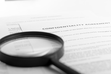 Search with magnifying glass, looking for information in books, blueprints, magazines. Audit inspection. Copy space text 