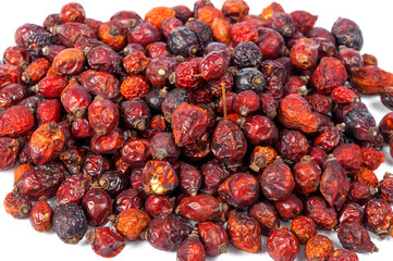 Pile of dried rose hips isolated on white background
