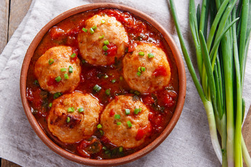 Chicken meatballs with tomato sauce in a clay bowl
