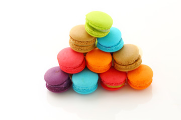 Colorful macarons on white background.