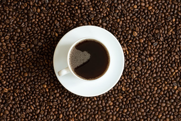 Cup of coffee on a coffee beans background