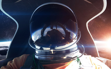 Brave astronaut in the spaceship cabin. This image elements furnished by NASA