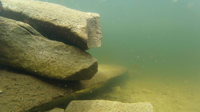 A Pile of Stones Under Water Glacial Lake in The
Highlands