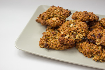 several homemade oatmeal cookies on a plate over white