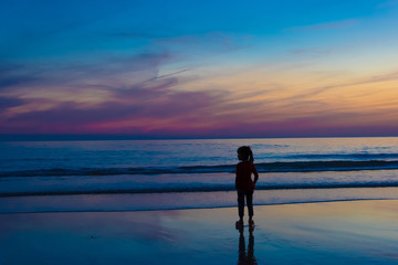 Fototapeta premium Siluate or Silhouette of people who spent time in the sea sand a
