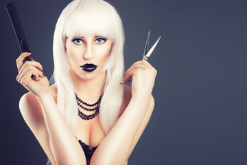 Obraz premium beautiful blonde woman with black make-up and accessories posing