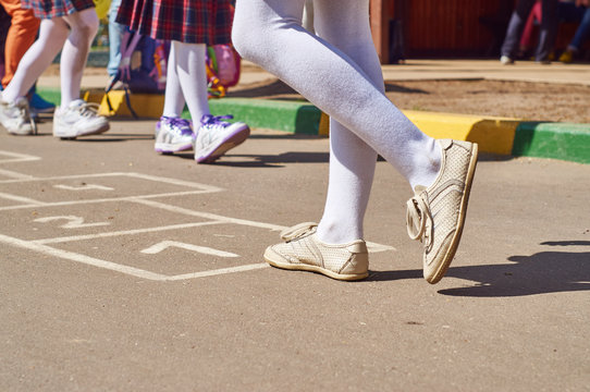  Children playing hopscotch at school yard after the lessons       