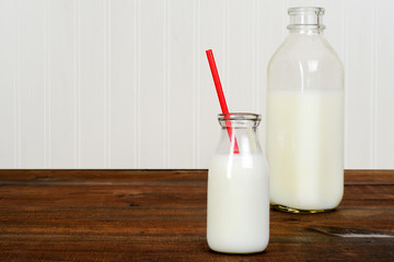 fresh glass of milk with bottle