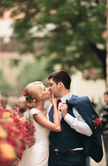 Fototapeta premium Beautiful couple, bride and groom posing on old balcony with column