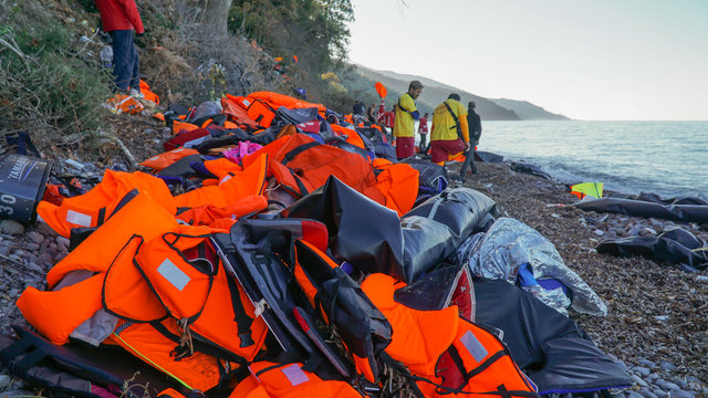 Abandoned belongings and life jackets on the shore